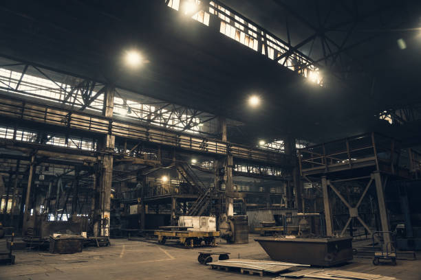 Industrial building inside. Metallurgical plant interior. Large dark Factory workshop stock photo