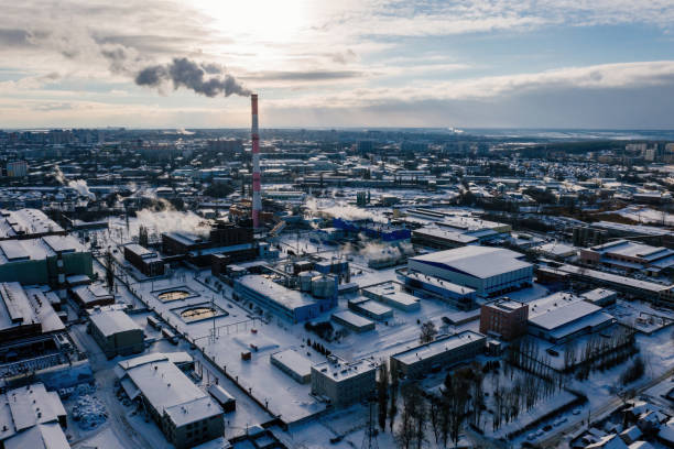 Industrial landscape at the sunset, aerial view. Smoke coming out from factory chimneys stock photo