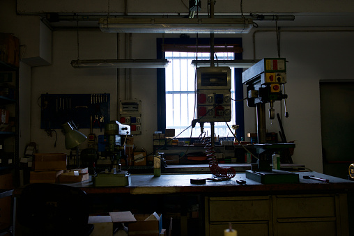 Industrial Mechanics Work Bench And Drilling Tools In Backlight