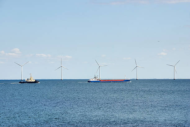 Industrial ships and wind turbines stock photo