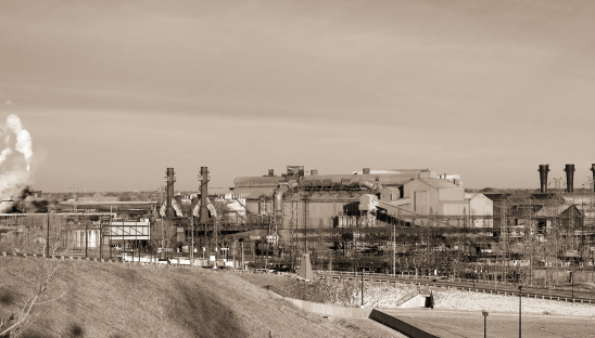 Sepia-toned view of old steel mill in an industrial valley