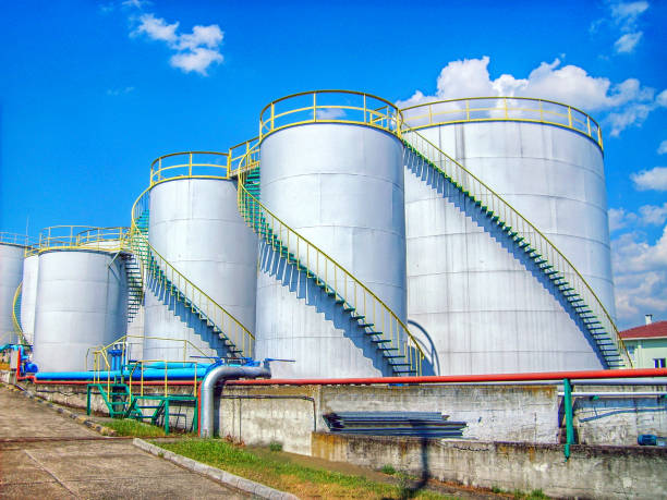 Industrial storage tanks and fire lines. Appearance of an oil and chemical storage facility. Industrial storage tanks and fire lines. Appearance of an oil and chemical storage facility. oil refinery factory stock pictures, royalty-free photos & images