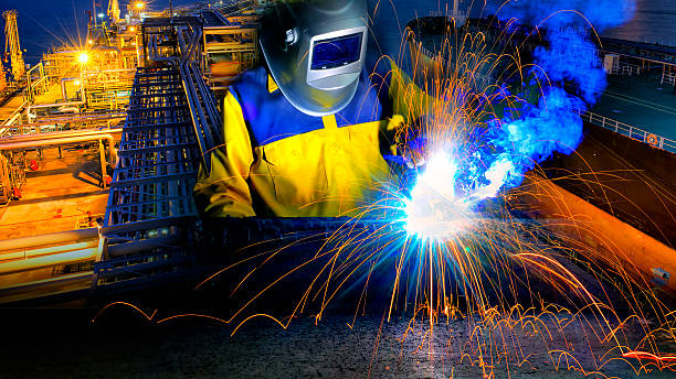 Industrial Worker in action welding close up stock photo