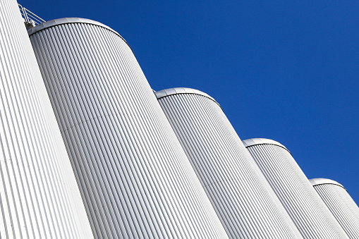 Exterior of modern white metal silos.