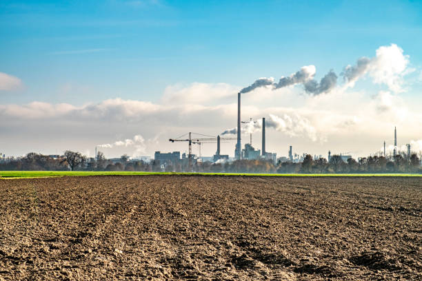 industry with chimneys and smoke at the horizon in Frankfurt stock photo