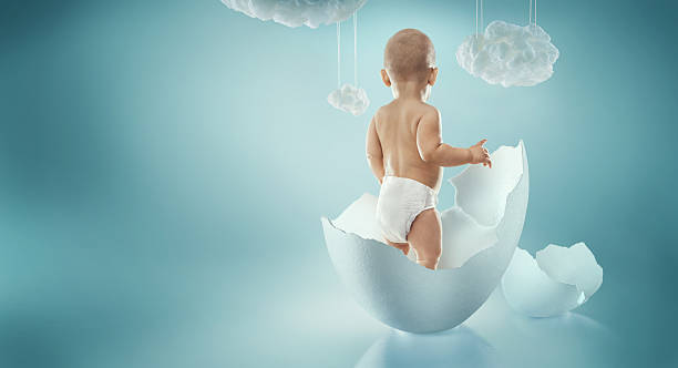 Infant child baby toddler standing in diapers in the egg. stock photo