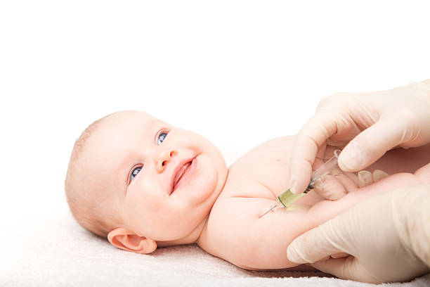 Infant gets an injection stock photo