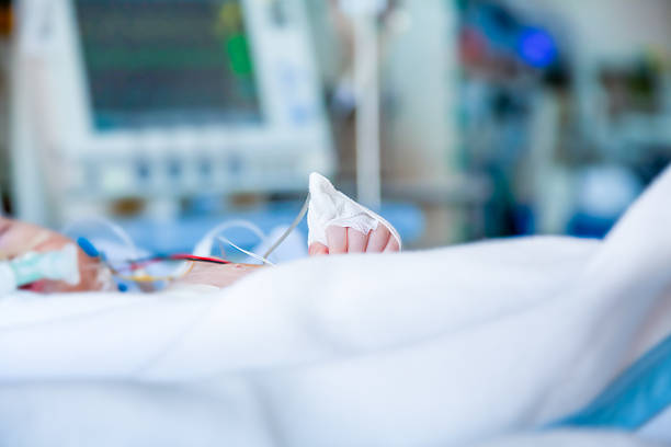 Infant in intensive care unit. Shallow depth of field profile. stock photo
