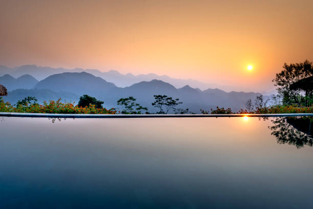Infinity pool at resort with a view of mountain at beautiful sunrise stock photo