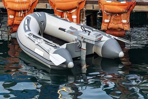 Fethiye, Turkey - August 24, 2021: Inflatable boat powered by outboard electric motor on sea. New technology outboard boat.