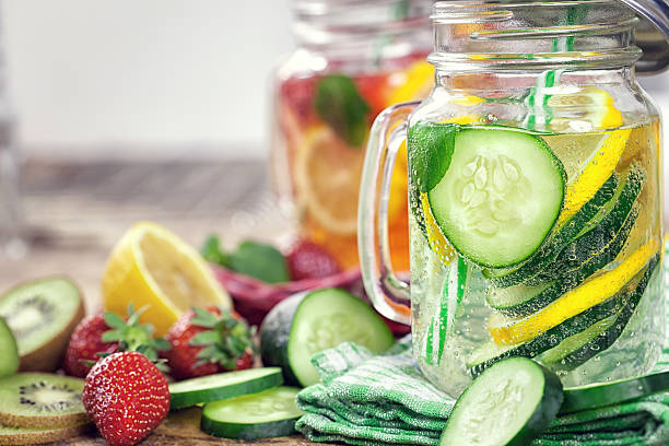 Infused Water with Fresh Strawberries, Lemon, Cucumber, Kiwi and Mint stock photo