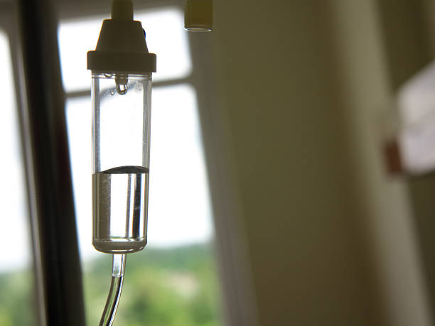 Infusion bottle with IV solution in hospital Infusion bottle with IV intravenous solution in hospital infusion therapy stock pictures, royalty-free photos & images