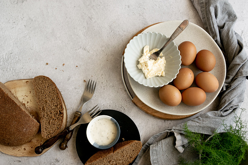 Ingredients for healthy farm cooking - eggs, whole wheat black bread, goat cream cheese and fresh raw fennel