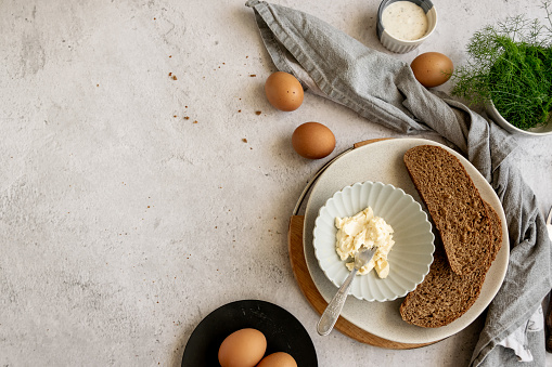 Ingredients for healthy farm cooking - eggs, whole wheat black bread, goat cream cheese and fresh raw fennel
