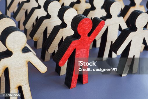 istock Initiative and activism concept. Unique figurine with a raised hand in a crowd. 1327075955