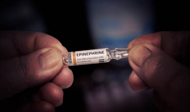 KYIV, UKRAINE-DECEMBER, 2019: Injection of Epinephrine Glass Ampoule. KYIV, UKRAINE-DECEMBER, 2019: Injection of Epinephrine. Medical Ampoule in a Wrinkled Hands of an Old Man. Healthcare and Old Age Concept with Medicines. Close Up. adrenaline stock pictures, royalty-free photos & images