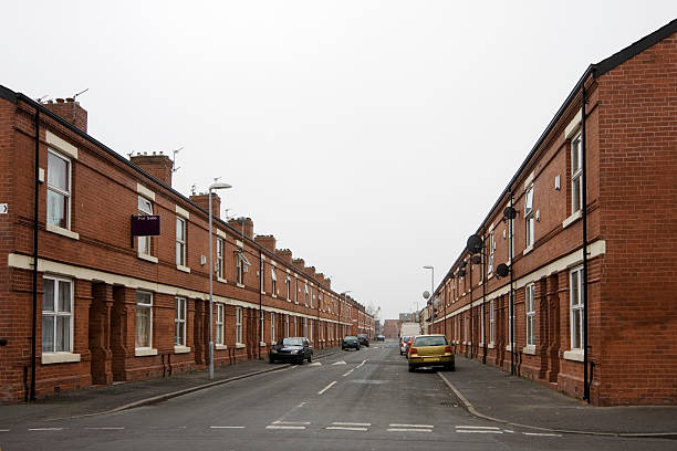 Inner city housing Street of row houses / terraced houses in an inner city area. This is Moss Side, Manchester, UK. northwest england stock pictures, royalty-free photos & images