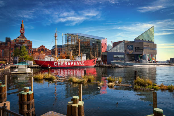 Inner Harbor Baltimore, Maryland / United States - November 25, 2017:  Buildings and ships reflect off the water of the Inner Harbor. inner harbor baltimore stock pictures, royalty-free photos & images