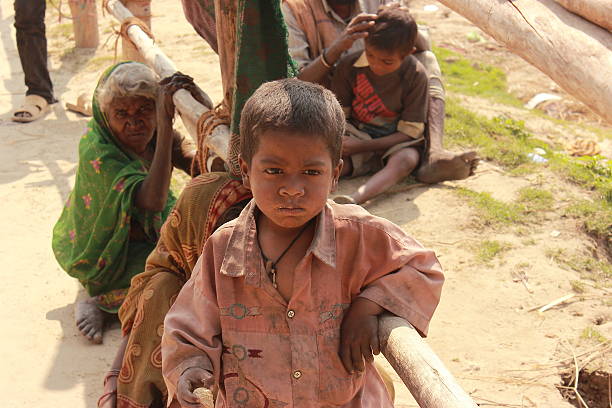 Innocence - poor boy in Kumbh 2013 stock photo