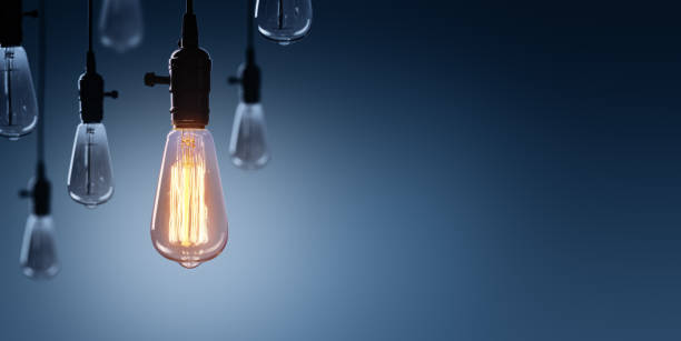 Innovation And Leadership Concept - Glowing Bulb lamp Glowing Bulb On Among Bulbs Off electricity photos stock pictures, royalty-free photos & images