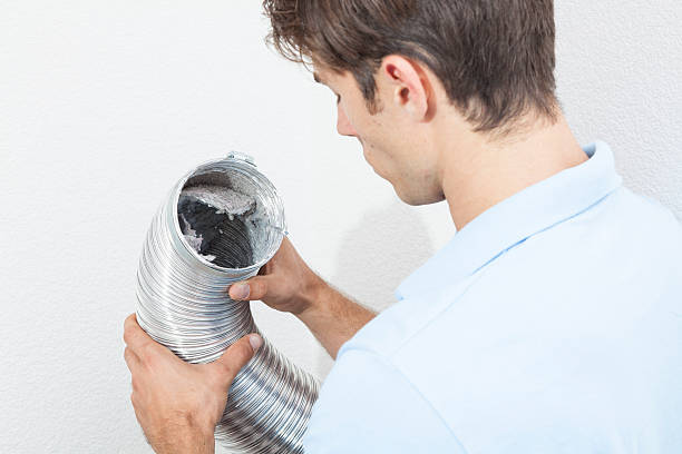 Inspecting Dryer Vent tube Man cleaning dryer vent in home. dryer photos stock pictures, royalty-free photos & images