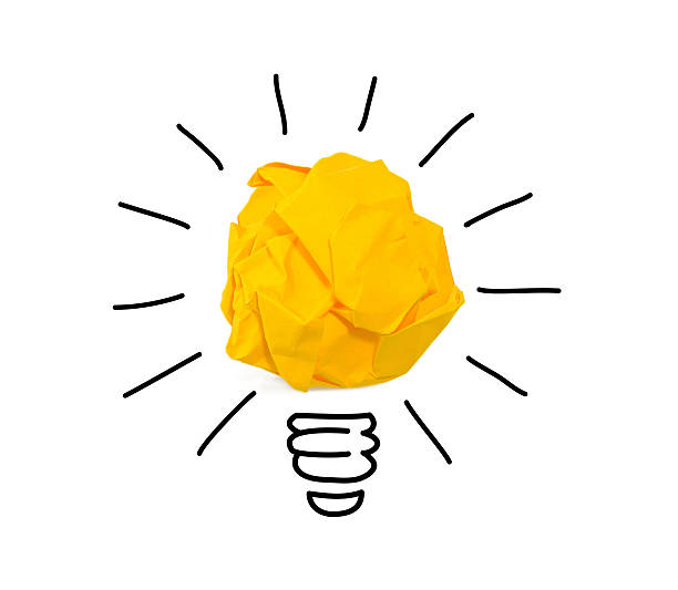Inspiration crumpled yellow paper light bulb idea stock photo