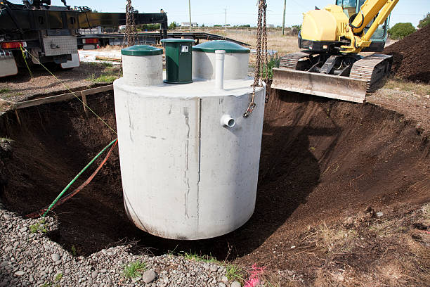 Installation of Septic System Environmentally friendly septic tank being lowered into ground.  More building a home:- poisonous stock pictures, royalty-free photos & images