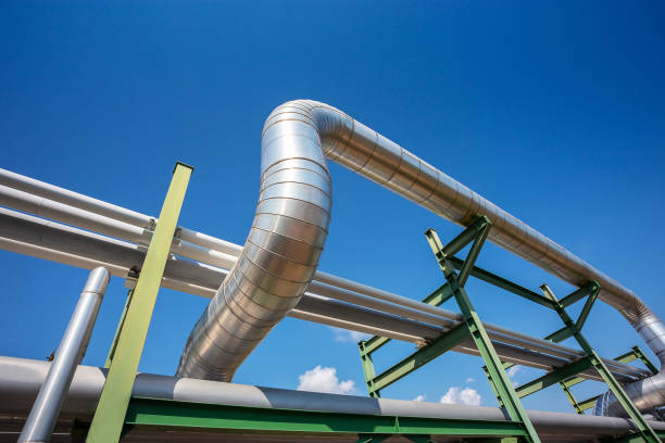 insulation of steam pipe for steam transportation on lack in industrial zone with clear blue sky stock photo