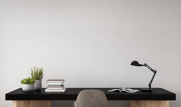 Interior hipster mock up wall background Office desk close up with chair. Empty gray wall template. Horizontal copy space interior setup. There is decoration, plant, table lamp, books, plants in a vase. Designer work background concrete wall photos stock pictures, royalty-free photos & images