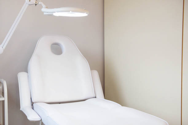 Interior of a cosmetology office.Modern equipment of cosmetology.White chair for cosmetology procedure. stock photo
