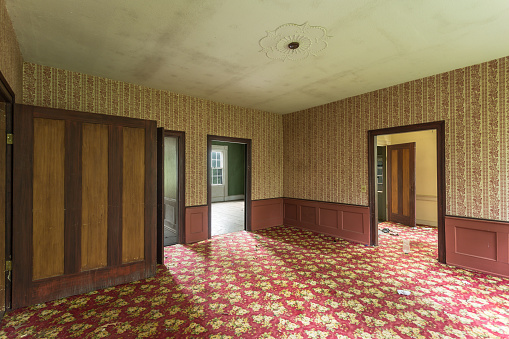 Interior of an abandoned house with crazy carpet
