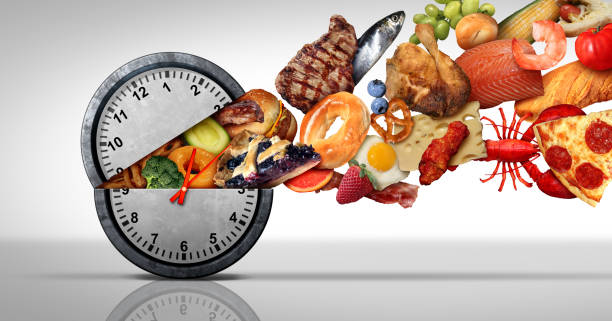 Intermittent Fasting Concept Intermittent fasting concept and calorie restriction or autophagy diet symbol nutrition concept and binge eating disorder with an open clock icon releasing food with 3D illustration elements. hungry photos stock pictures, royalty-free photos & images