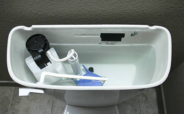 Internal Plumbing of a Modern Toilet Internal plumbing of the inside of a tank of a modern toilet storage tank stock pictures, royalty-free photos & images