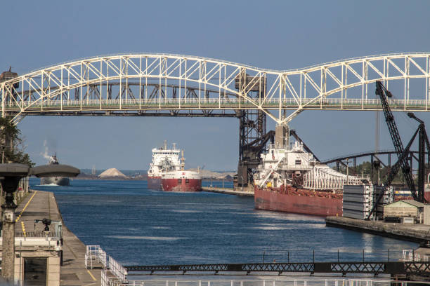 International Bridge With Freighters Waiting To Enter The Soo Locks In Sault Ste Marie Michigan stock photo