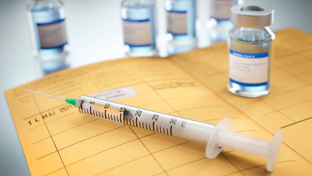 International certificate of vaccination with syringe and vial stock photo