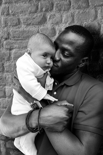 immigrant father with baby against racism