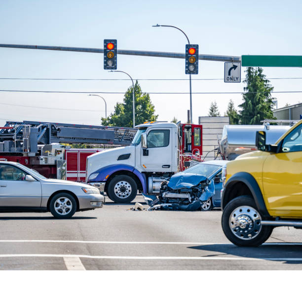 Intersection accident involving a car and a big rig semi truck with tank semi trailer stock photo