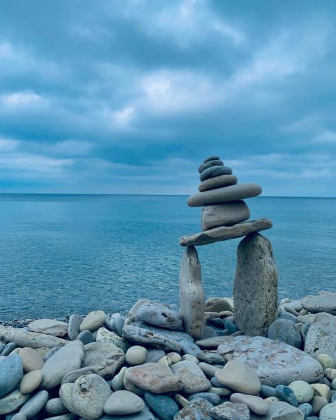 Inukshuk Stone Statue with Lake Huron at the backdrop - Bruce Peninsula Ontario Cape Chin, Bruce Peninsula ON bruce peninsula national park stock pictures, royalty-free photos & images