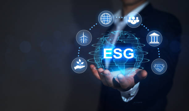 Investing strategy  for sustainable and ethical business. Businessman  holding digital globe with ESG icons. Development technology of renewable resource to reduce pollution. stock photo