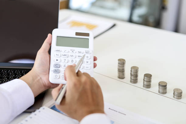 Investors are calculating their investments using a calculator. stock photo