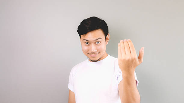Inviting or calling hand sign. stock photo