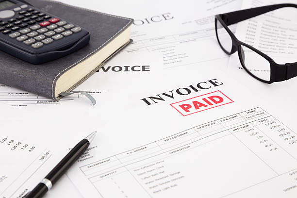 Invoice and bills with paid stamp close-up picture of invoices with red paid stamp, paperwork at office paid stamp stock pictures, royalty-free photos & images