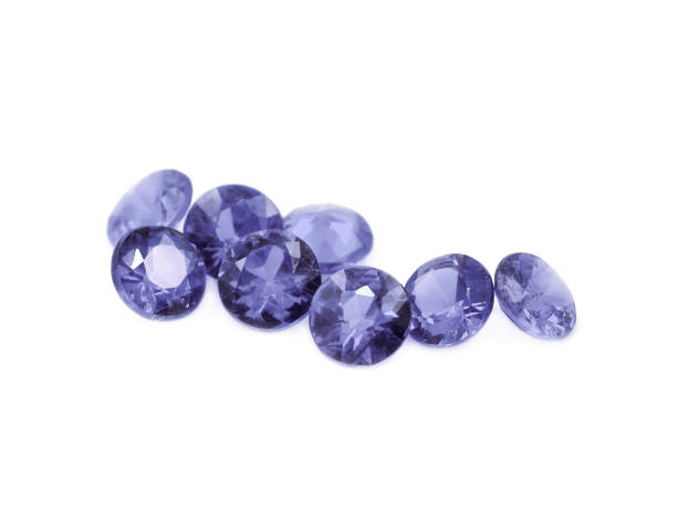Iolite gems on a white Purple diamond cut gems on a white background. zoisite photos stock pictures, royalty-free photos & images