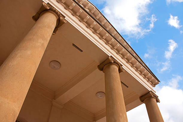 Ionic order in classical architecture against blue sky.