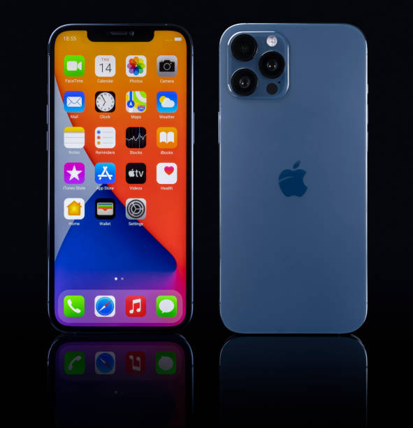 iPhone 12 Pro Max blue on black glass stock photo