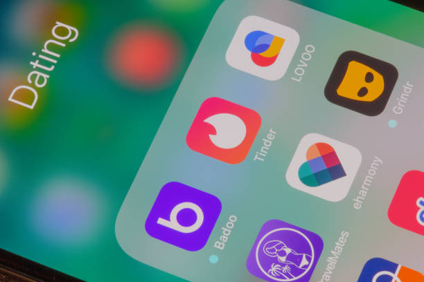 Iphone with app-logos Nuremberg, Germany - December 29, 2018: A close-up photo of Apple iPhone screen with icons, includes Tinder, Lovoo, Badoo, Grindr and other dating apps. - Image dating stock pictures, royalty-free photos & images