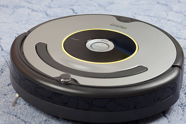 iRobot Roomba Vacuum Cleaning Robot Tambov, Russian Federation - January 26, 2014: iRobot Roomba 630 Vacuum Cleaning Robot on blue carpet. Studio shot.  roomba stock pictures, royalty-free photos & images