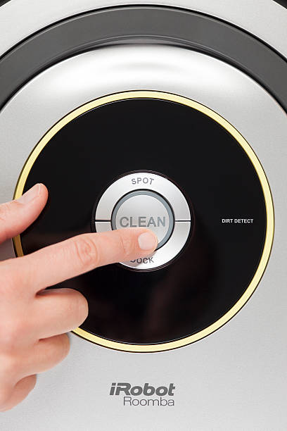 iRobot Roomba Vacuum Cleaning Robot Tambov, Russian Federation - January 26, 2014: iRobot Roomba 630 Vacuum Cleaning Robot. Woman's finger pressing the button "Clean" to starting cleaning. Studio shot.  roomba stock pictures, royalty-free photos & images