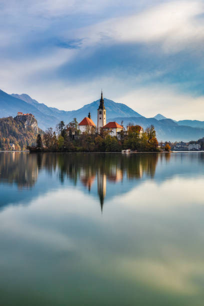 Island with a church and reflection in calm water of lake Bled stock photo