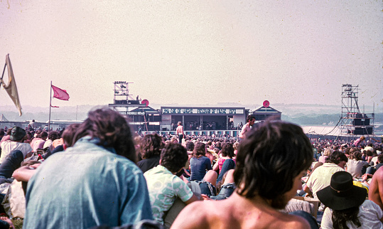 Isle of Wight, England - August 30, 1970: Vintage photo of crowd attending the Isle of Wight Music Festival, attended by over 600,000 people. Musical groups that performed included the Doors, The Who, Joan Baez, Jimi Hendirx, Kris Kristofferson, Donovan, the Moody Blues, Jethro tull, Richie Havens,